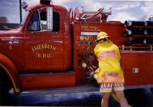 Firefighter beside a fire apparatus