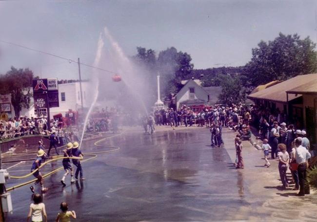 Firefighters spraying water from a hose
