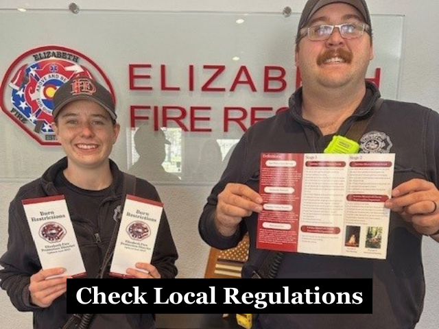 Firefighters holding burn flyers with the caption "Check Local Regulations"