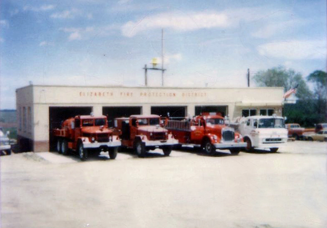 Fire vehicles parked in front of a fire station