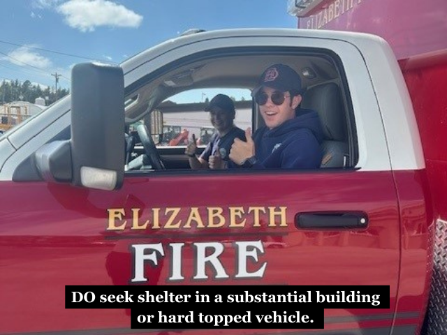 Firefighters in a fire vehicle with the caption "DO seek shelter in a substantial building or hard topped vehicle."