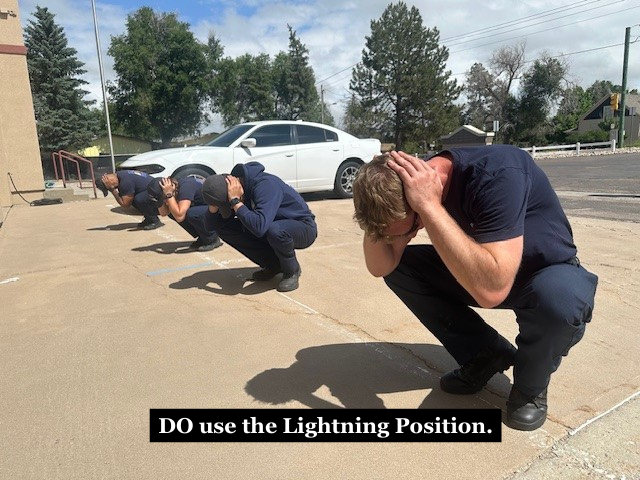 Firefighters demonstrating the lightning position with the caption "DO use the Lightning Position."