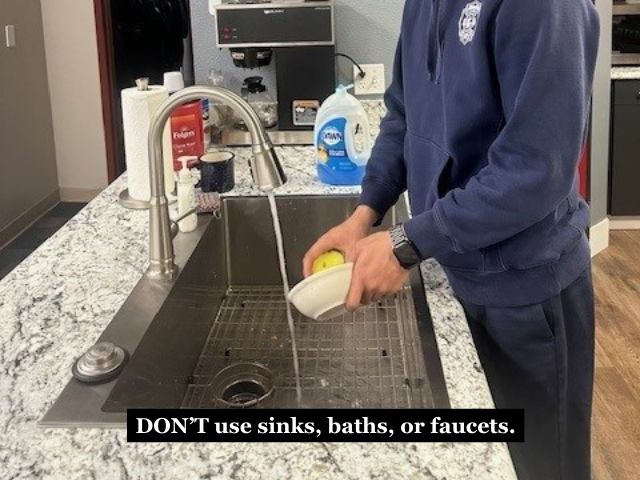 A firefighter washing dishes with the caption "DON'T use sinks, baths, or faucets."
