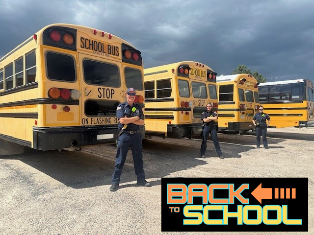 Firefighters standing in front of school buses with the caption "Back to School"