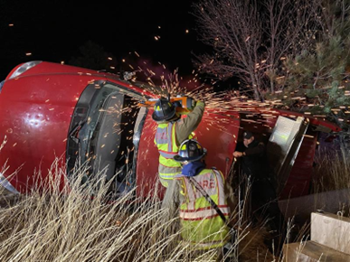 Firefighters use extrication tools on a car accident