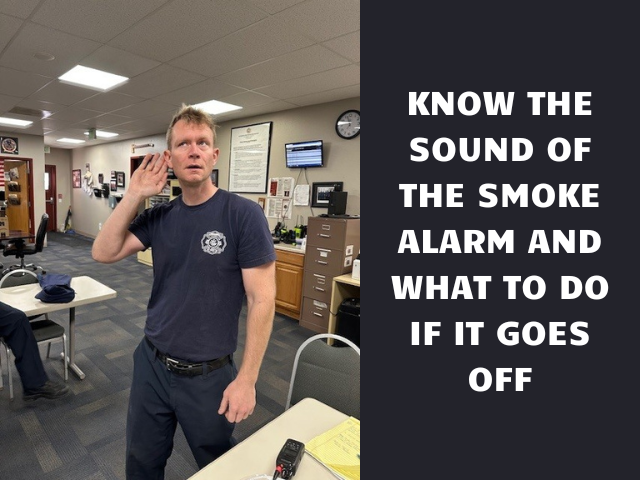 A firefighter listening for a smoke alarm with the caption "Know The Sound Of The Smoke Alarm And What To Do If It Goes Off"