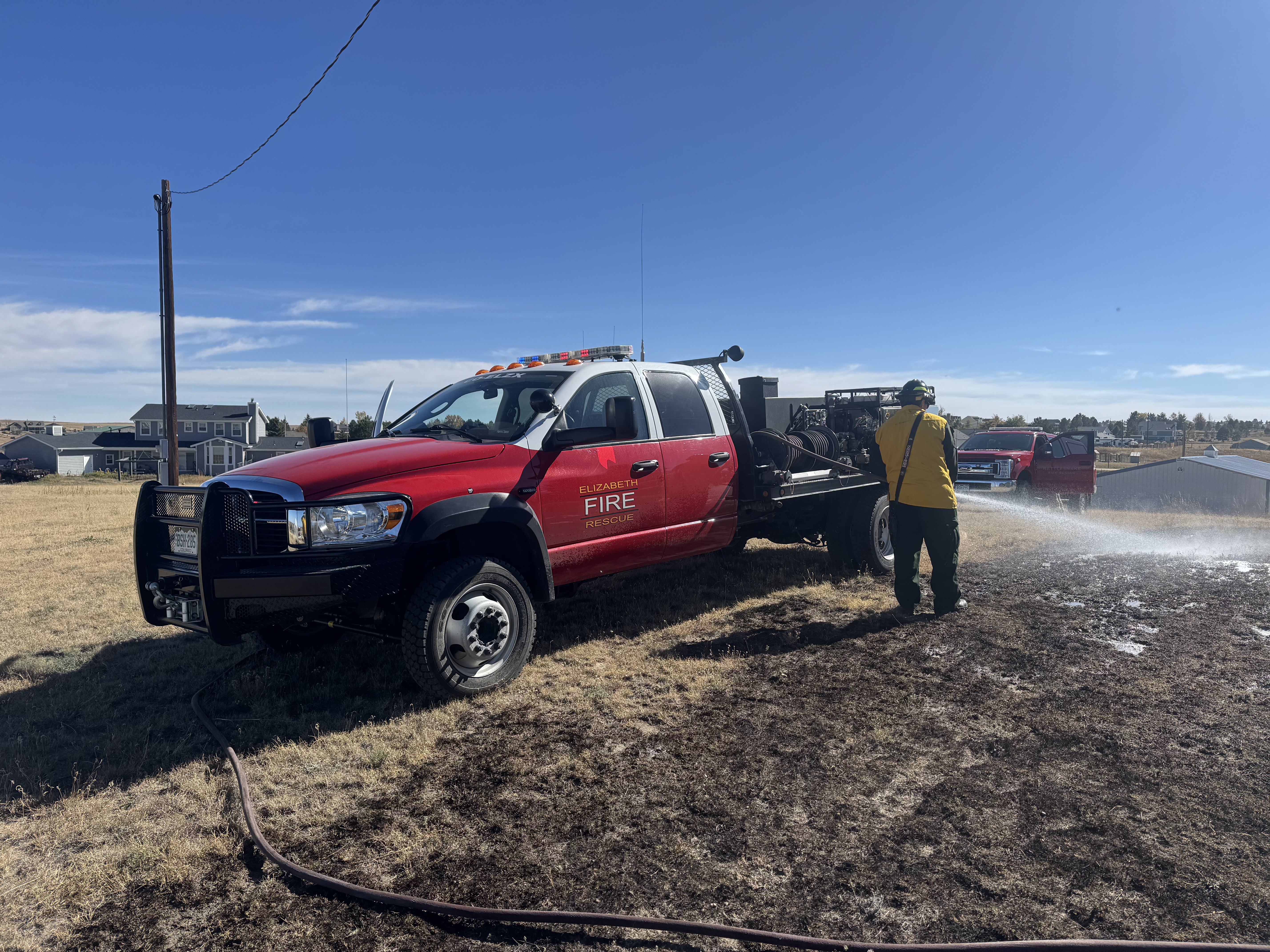 Crews and a brush truck on a fire