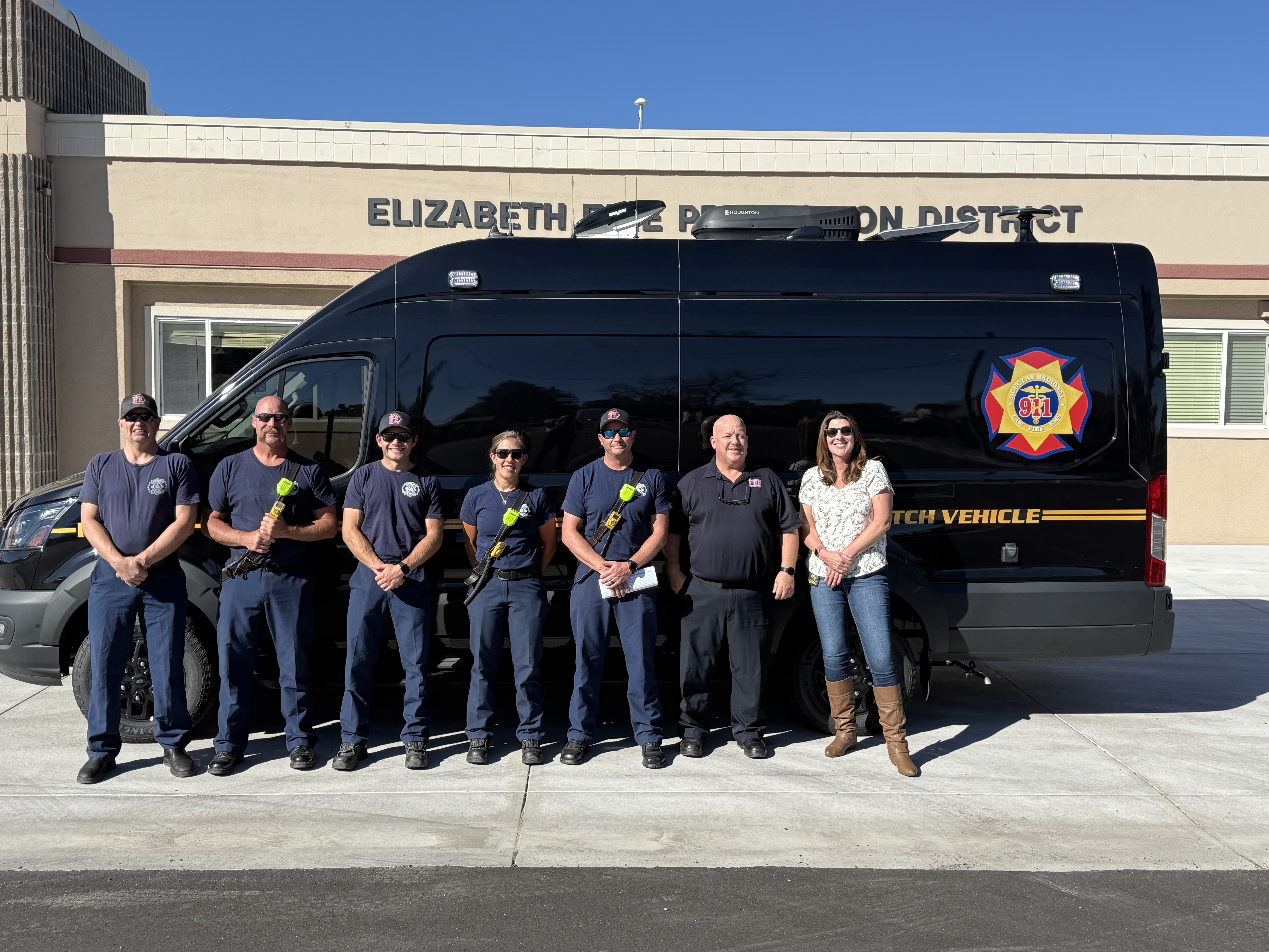 Crews in front of an incident dispatch vehicle (IDV)