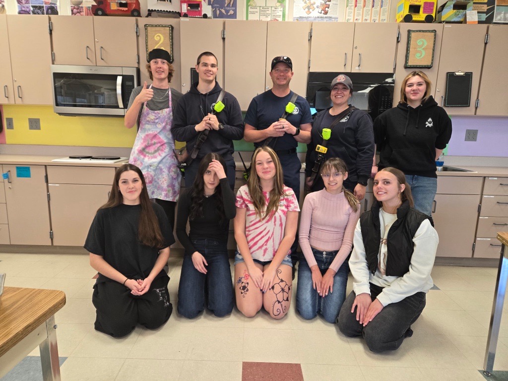 Firefighters and kids during a cooking class