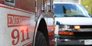 Side of fire apparatus with "Emergency 911" written on it