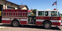 A fire engine parked outside of a fire station