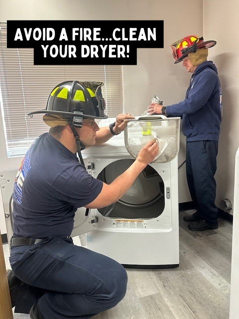 Firefighters cleaning dryer lint screen and vent with the caption "Avoid a Fire...Clean Your Dryer!"